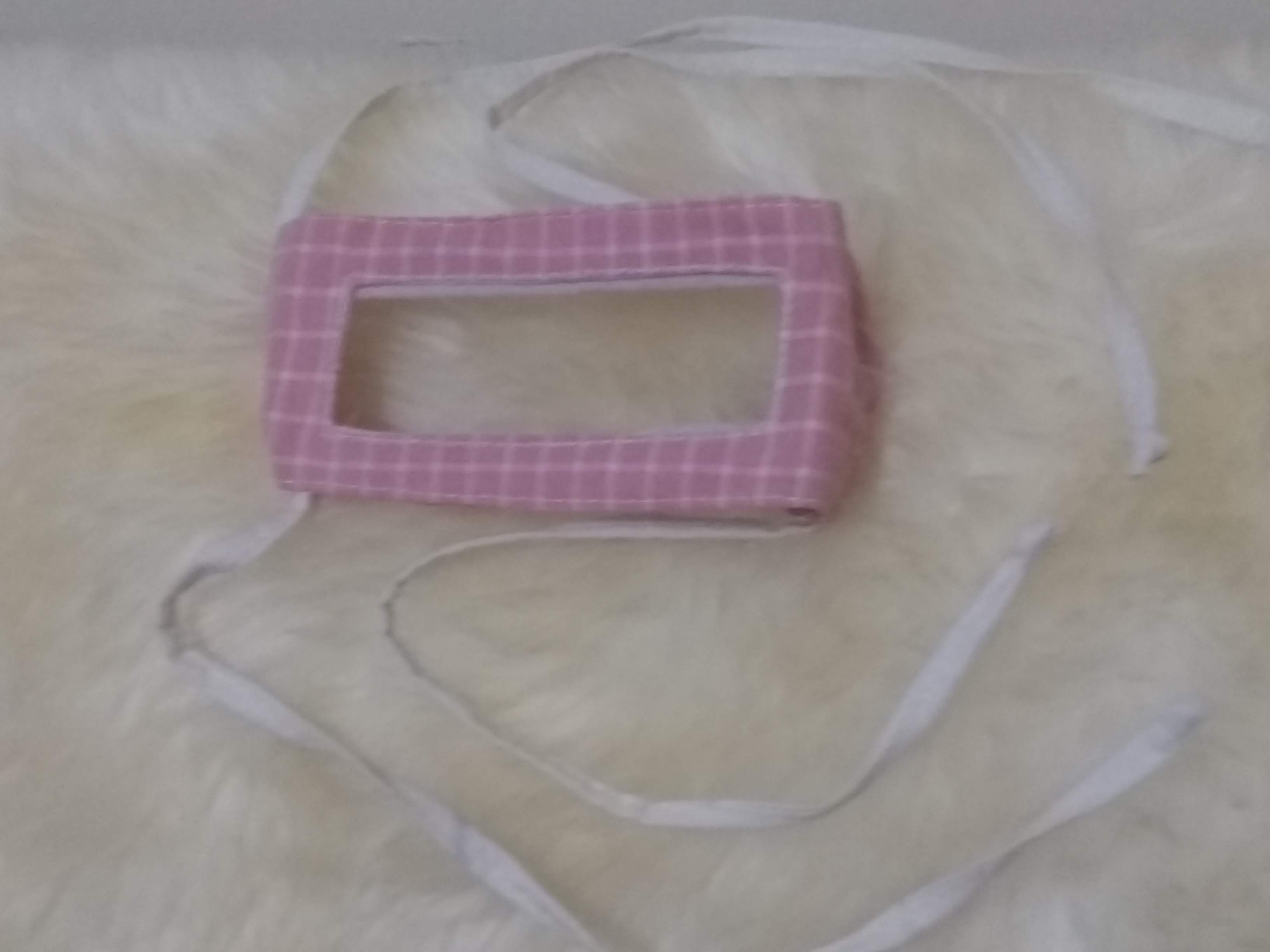 image of a windowed facemask in pink with white squares